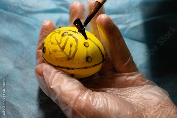 Fototapeta Painting Easter eggs with wax and creating patterns. Ukrainian traditions for Easter