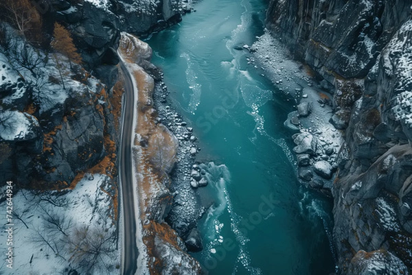 Fototapeta This aerial view captures a river meandering through a deep canyon, showcasing the natural beauty of the landscape as the water flows effortlessly through the rocky terrain
