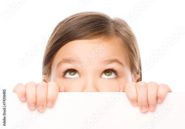 Obraz Little girl is looking from out blank board