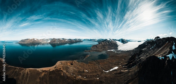 Fototapeta drone shot for breathtaking footage of wild nature in svalbard, majestic mountains in the clouds, massive river and nature under the cloud, useful for newspapers and magazines, travel to unspoiled 