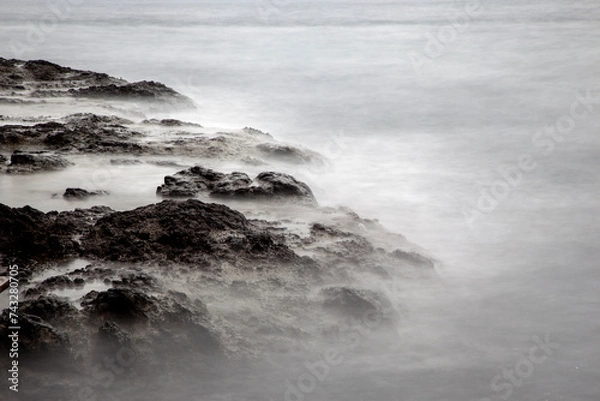 Obraz Long-exposure of the surf at the rocky seaside