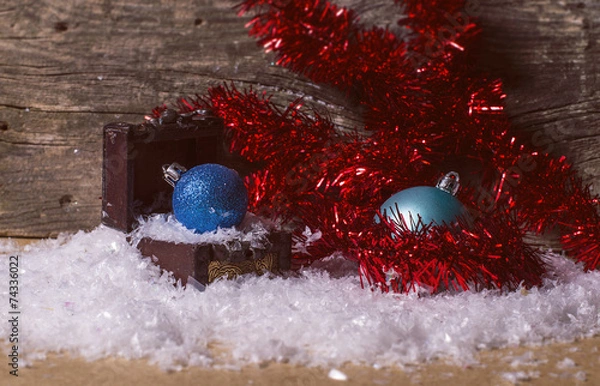 Obraz Blue christmas baubles and red tinsel