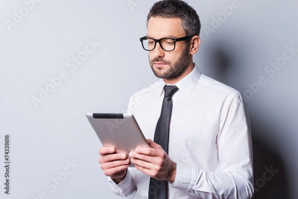 Fototapeta Examining new tablet.