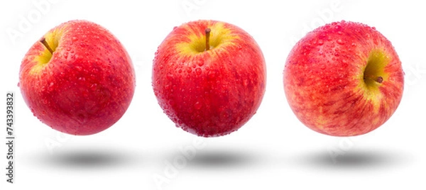 Obraz Flying red apple has water drop collection and shadow isolated on white background.