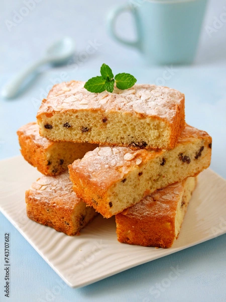 Obraz Sponge cake with chocolate chunks and almonds,