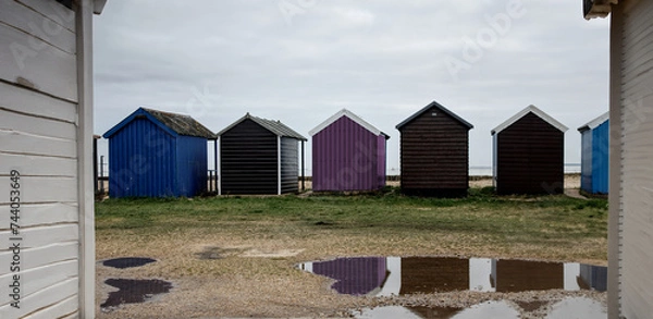 Obraz multicoloured beach huts on a wet day