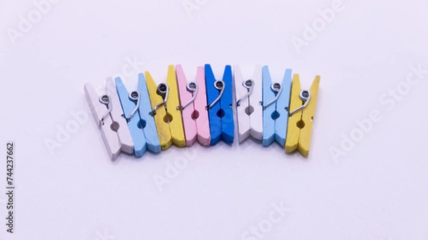 Fototapeta colored clothespins attached in the center of the image