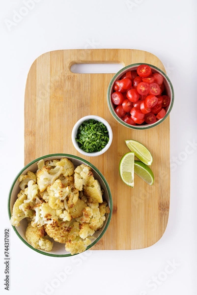 Fototapeta Roast cauliflower tomatoes and hummus salad