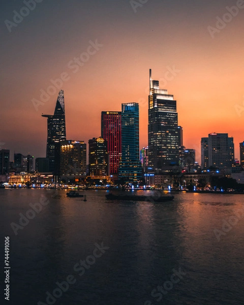 Obraz A sunset view of Ho Chi Minh city from over the Mekong river