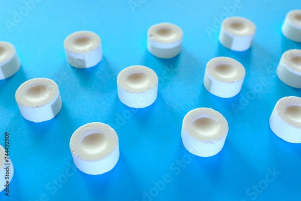 Fototapeta 青い背景に置かれた白いお菓子のラムネたち