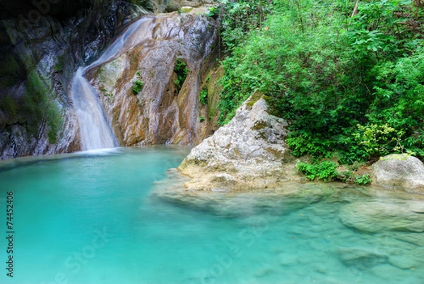Fototapeta Natural pool with azure water and a small waterfall