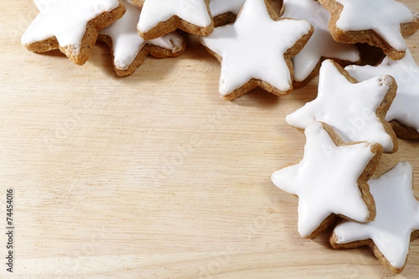 Obraz Christmas background, cinnamon stars on wooden board