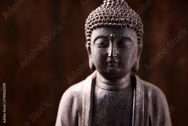 Fototapeta Meditating Buddha Statue on dark background. Soft focus. Close up. Copy space.	