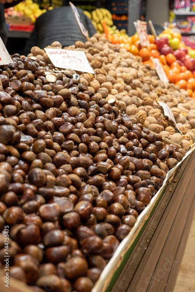 Fototapeta chestnuts and shelled dried walnuts for sale in the market
