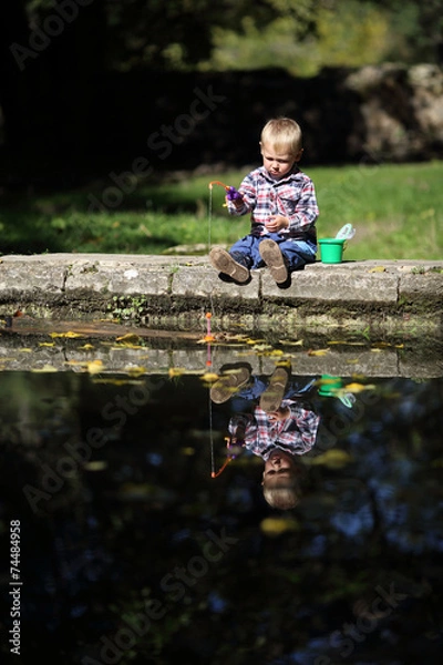 Fototapeta funny boy  catches a fish