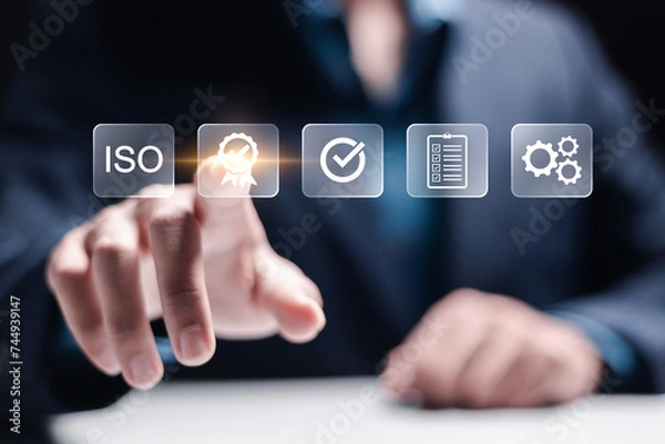 Fototapeta ISO Certification and standardization process concept. Certificate, Approval, Compliance to requirements. Businessman touching quality assurance icon for international standards.