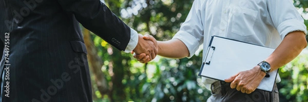 Fototapeta .World Environment Day business partner colleagues shaking hands during a meeting working together in sustainability. Save Earth, World Environment Day concept, Earth Day.