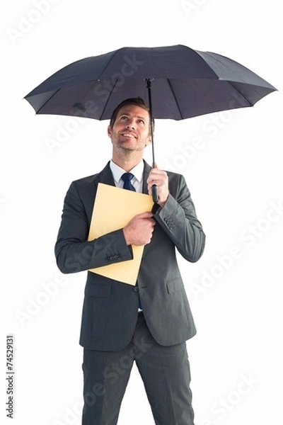 Fototapeta Businessman sheltering under umbrella holding file