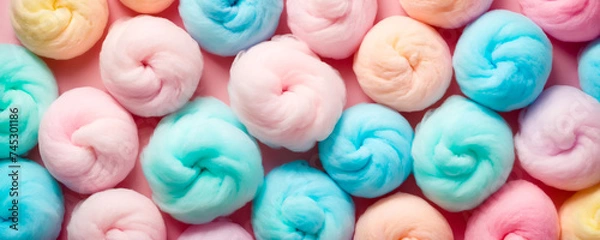 Fototapeta A close-up of many fluffy swirls of cotton candy, showing a variety of soft pastel tones that evoke a feeling of sweetness.