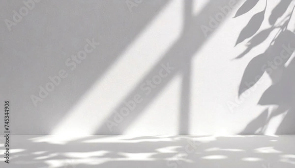 Fototapeta Play of light and shadows of straight lines and leaves on a monochrome background with lighting from the window