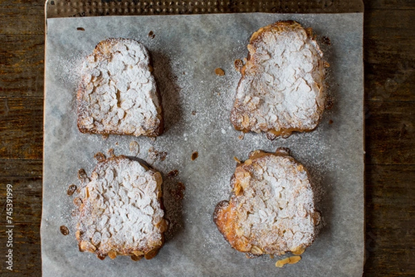Fototapeta Sweet bread cut into slices and spread with a thin fruit glaze and topped with an almond spread