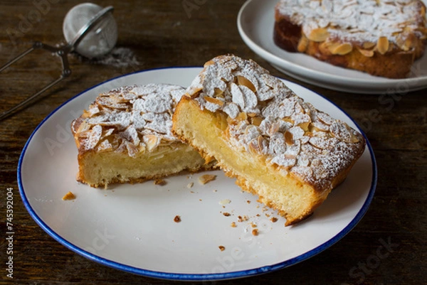 Fototapeta Sweet bread cut into slices and spread with a thin fruit glaze and topped with an almond spread