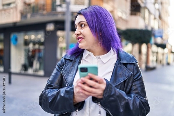 Fototapeta Young beautiful plus size woman smiling confident using smartphone at street