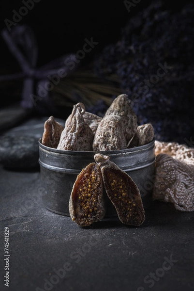 Fototapeta Close up of dried figs and dried lavender in the background.