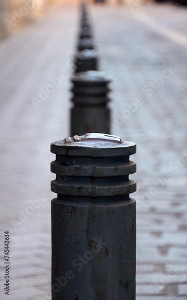 Fototapeta A street scene capturing a row of bollards