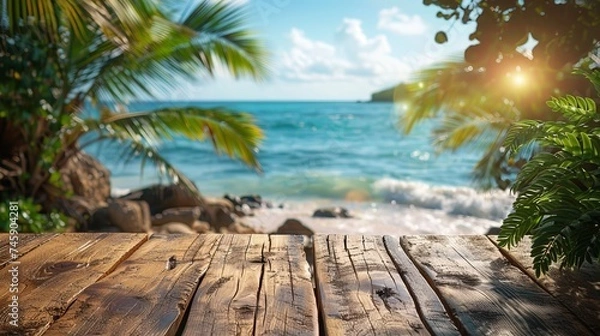 Fototapeta Top of wooden table with seascape and palm leaves, sea and sky bokeh blur against tropical beach background. Blank ready-to-mount display of your product. summer vacation concept