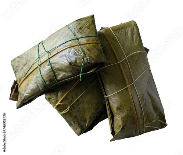Fototapeta Three tamales wrapped in banana leaf on white background.