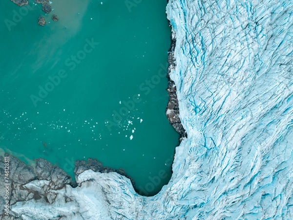Fototapeta drone shot of an iceberg in Svalbard, a large piece of iceberg on the water in the middle of wild and frozen nature, usable for magazines and magazines, travel to arctic countries, Svalbard