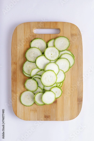 Fototapeta Cucumber sliced on a wooden chopping board and white background ingredient for recipe