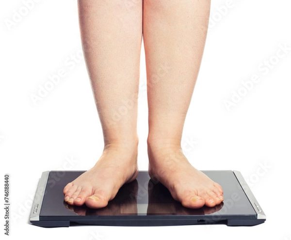 Obraz Bare female feet standing on bathroom scale