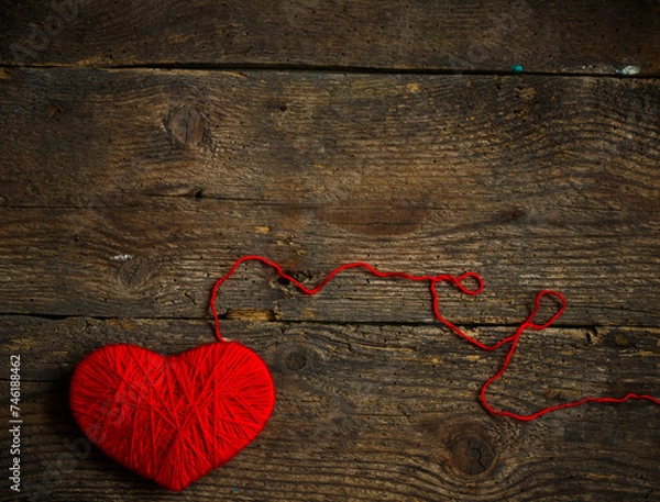 Obraz Red heart shape made from wool on old shabby wooden background