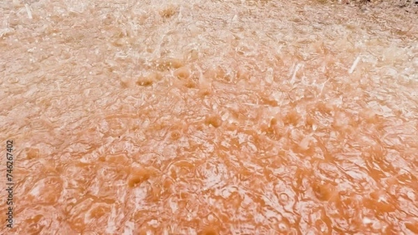 Obraz Raindrops falling into a puddle slow motion