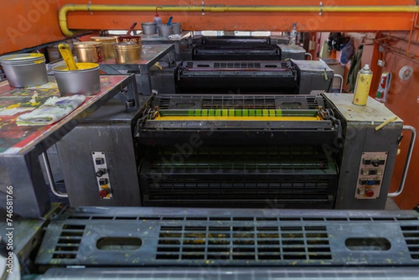 Fototapeta Offset printing machines. Large printing machine perspective. printing machine cylinders and printing ink pot. Offset machine. Offset press is a printing machine designed to produce fine quality