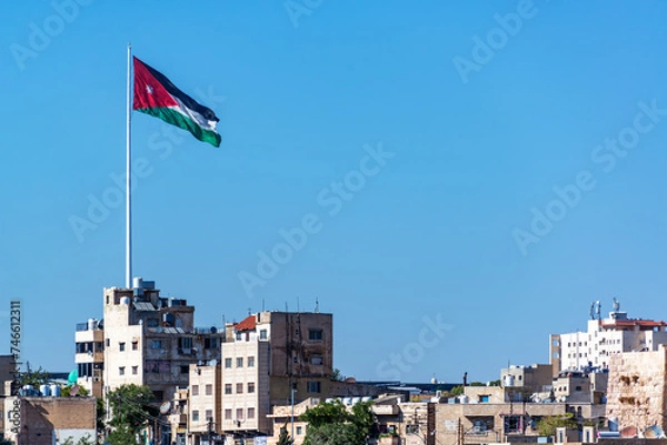 Obraz Large Jordanian flag flying over the city of Amman, Jordan