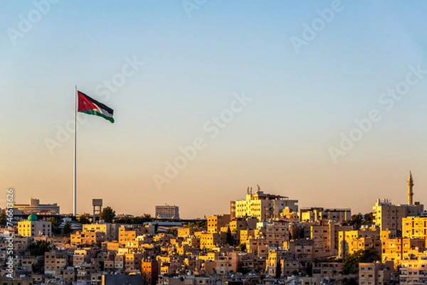 Obraz Beautiful sunset cityscape of Amman, Jordan with Jordanian flag flying in the wind