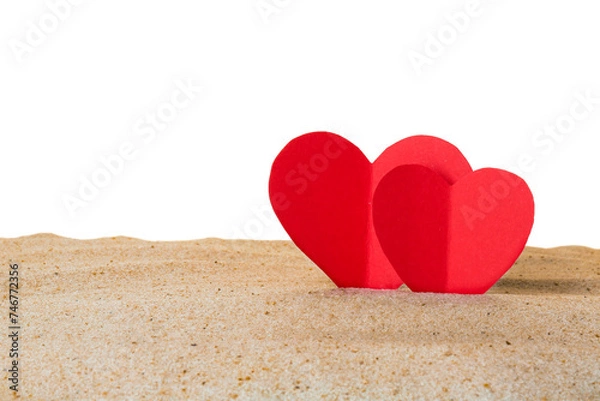 Fototapeta Honeymoon concept. Two red paper hearts and sand isolated on white