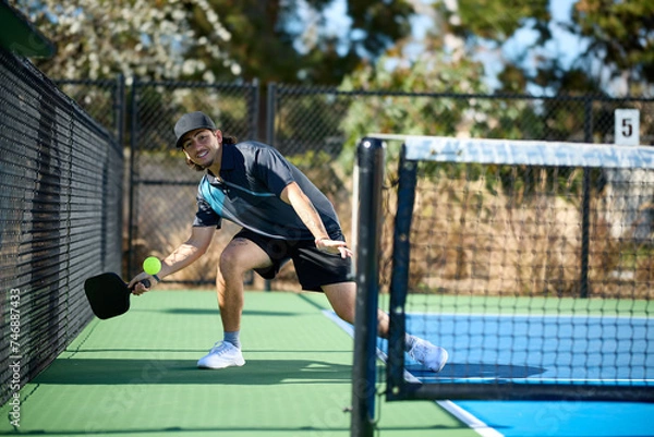 Fototapeta A pickleball player hitting an "ATP" shot