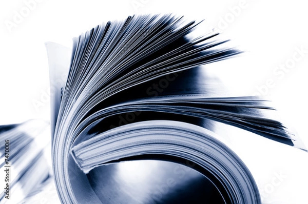 Fototapeta Closeup of rolled magazine pages, on white