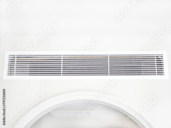 Obraz Air conditioning wall mounted ventilation system on ceiling in the hotel room. Closeup photo, blurred.