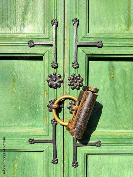 Obraz a fragment of an old green wooden door, upholstered in metal and closed with an old bronze padlock. Door is located in the Gyeongbokgung Palace complex of Joseon dynasty, built in 1395.