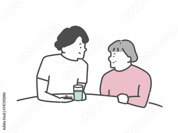 Obraz 高齢女性の服薬介助を行う女性介護士