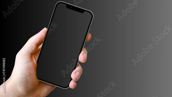 Fototapeta Hand holding cell phone mockup with blank screen. Smartphone mock up isolated on black bacground