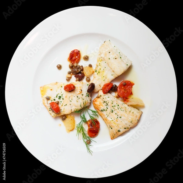 Fototapeta Fried fish fillet with capers isolated on black