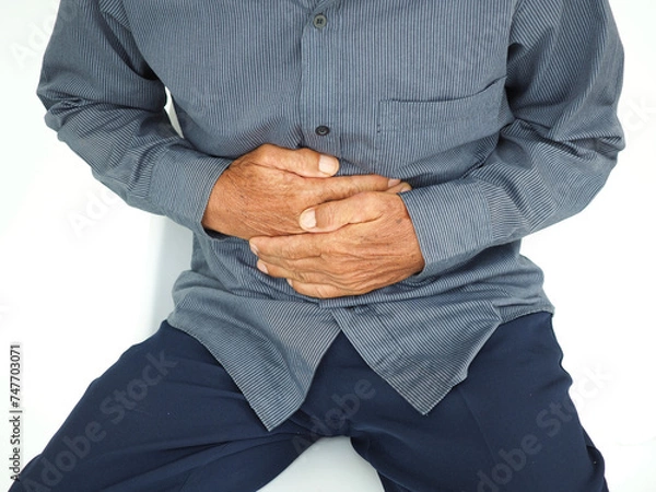 Obraz Man with stomach pain causes of abdominal pain include inflammatory bowel disease-IBD. stomach ulcer irritable bowel syndrome (IBS), ulcerative colitis and microvilli. Medical concept.