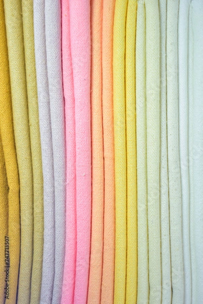 Fototapeta stack of colourful cotton clothes, close up pile of clothing