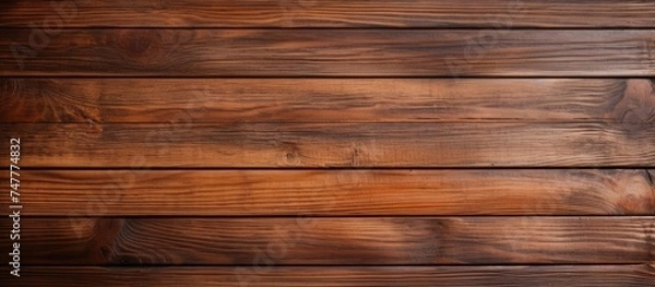 Fototapeta A close-up view of a weathered wooden wall against a brown background. The textured surface of the wood adds depth to the image, creating a rich visual contrast.